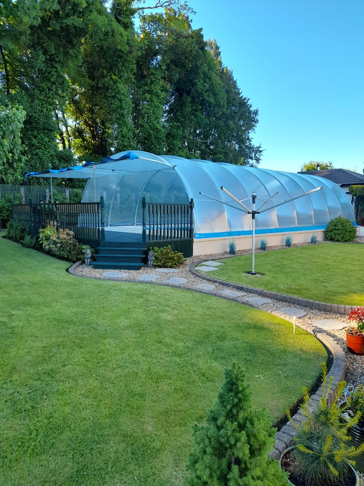 Pool enclosure around an outdoor swimming pool